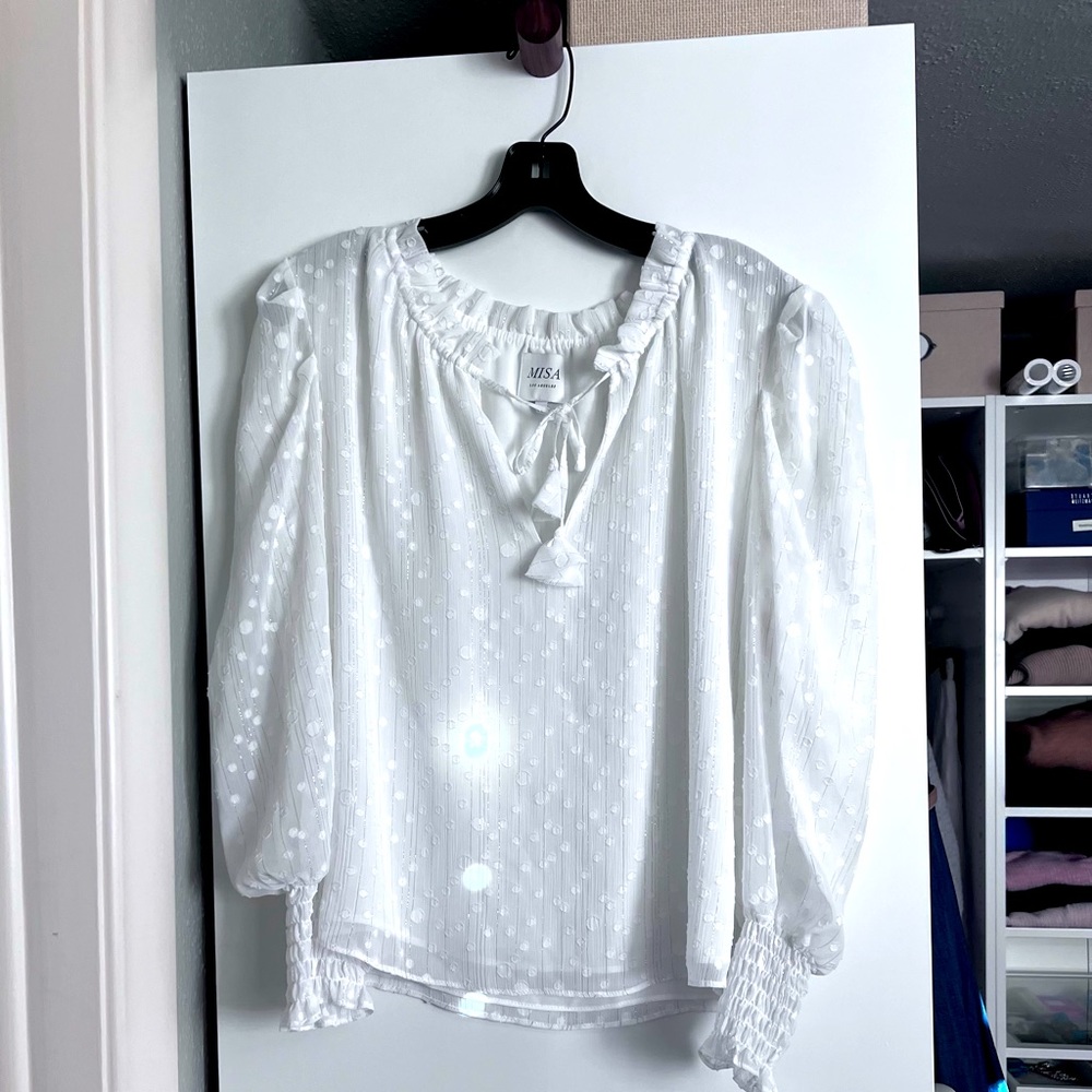 Charming top with light polka dots and delicate gold sparkles throughout.